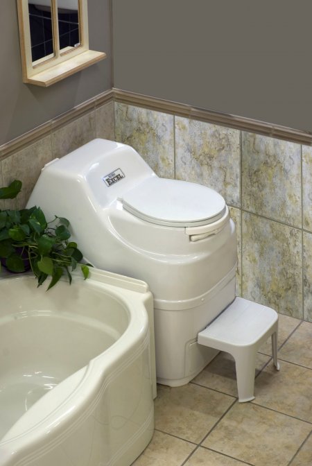 Sun-Mar Excel composting toilet in a tiled bathroom